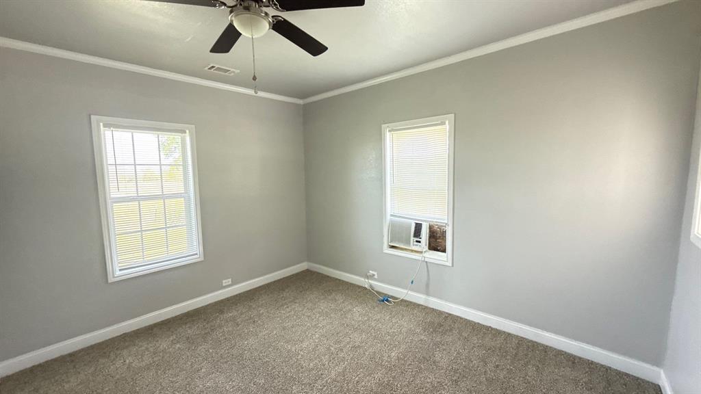 1338 State Highway 121 Bonham, TX 75418 - Photo 19 of 32 an empty room with a window and ceiling fan