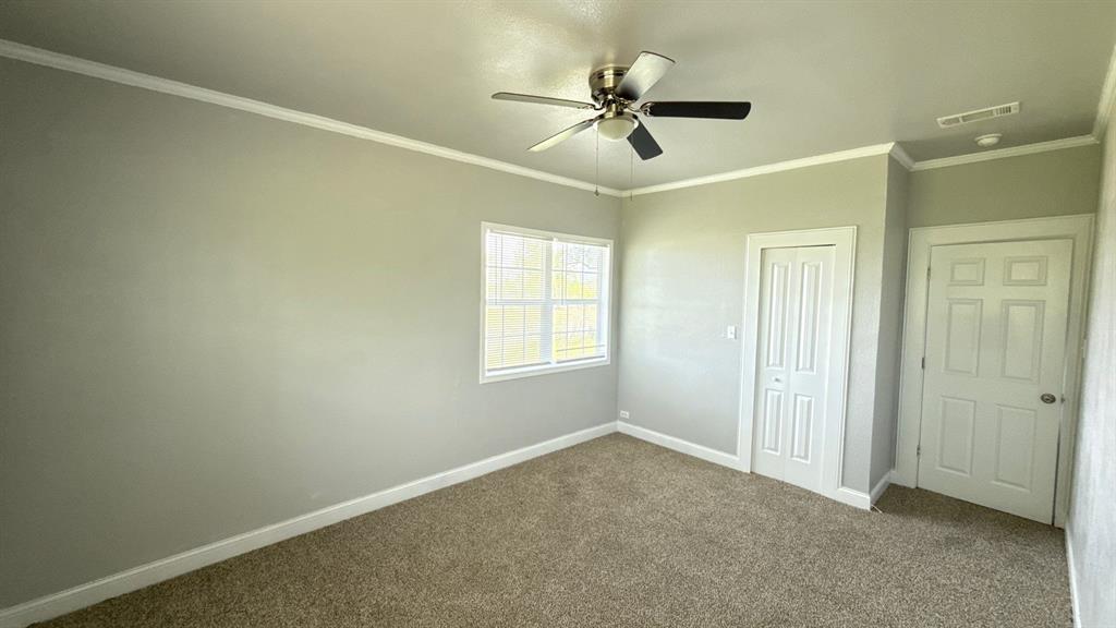 1338 State Highway 121 Bonham, TX 75418 - Photo 20 of 32 a view of a livingroom with a ceiling fan & windows