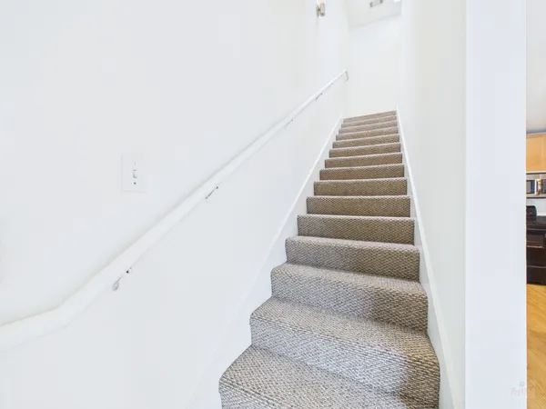 a view of staircase with white walls