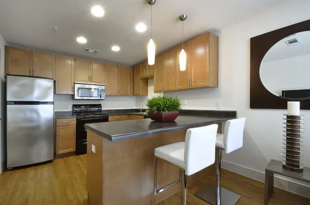 a kitchen with kitchen island a appliances a sink and a refrigerator
