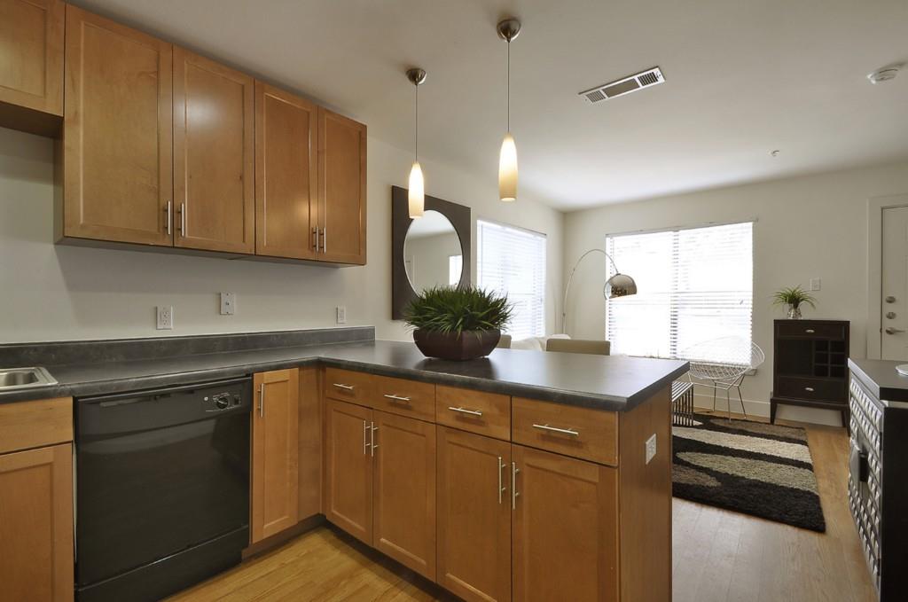 711 West 32nd Street, Unit 108 Austin, TX 78705 - Photo 17 of 28 a kitchen with sink cabinets and appliances