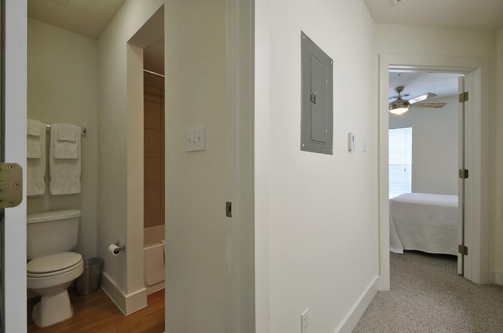 711 West 32nd Street, Unit 108 Austin, TX 78705 - Photo 18 of 28 a bathroom with a granite countertop toilet a sink and a mirror