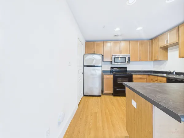 a kitchen with a refrigerator and a sink
