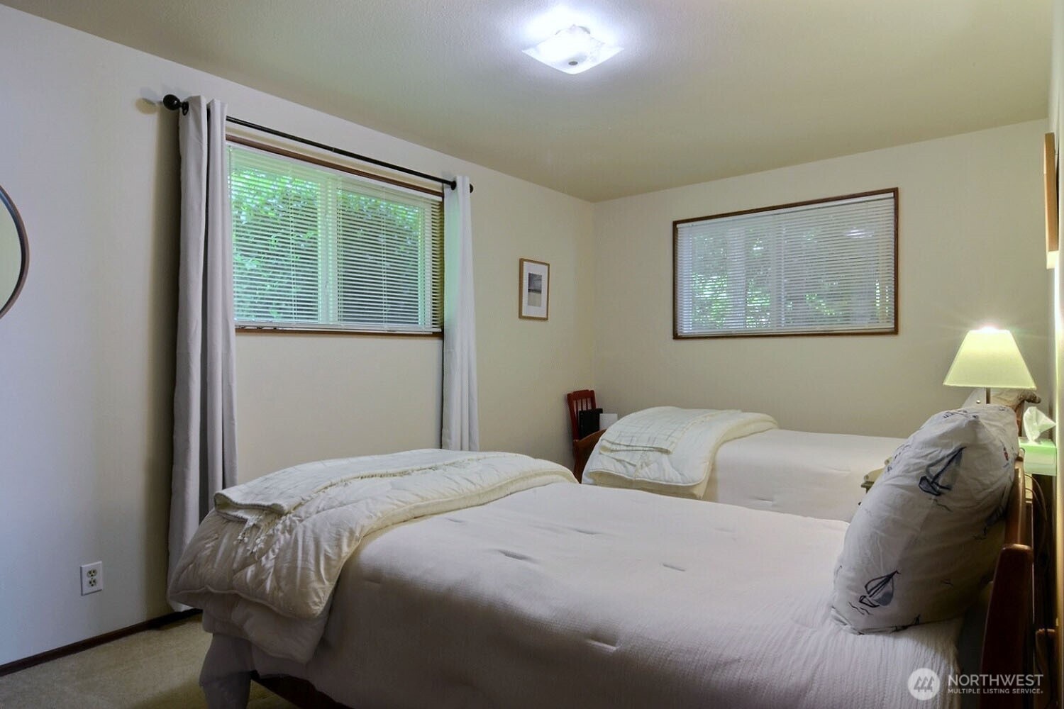 7504 Crescent Beach Rd Nortwest Vaughn, WA 98394 - Photo 19 of 40 a bedroom with a bed and a painting on the wall