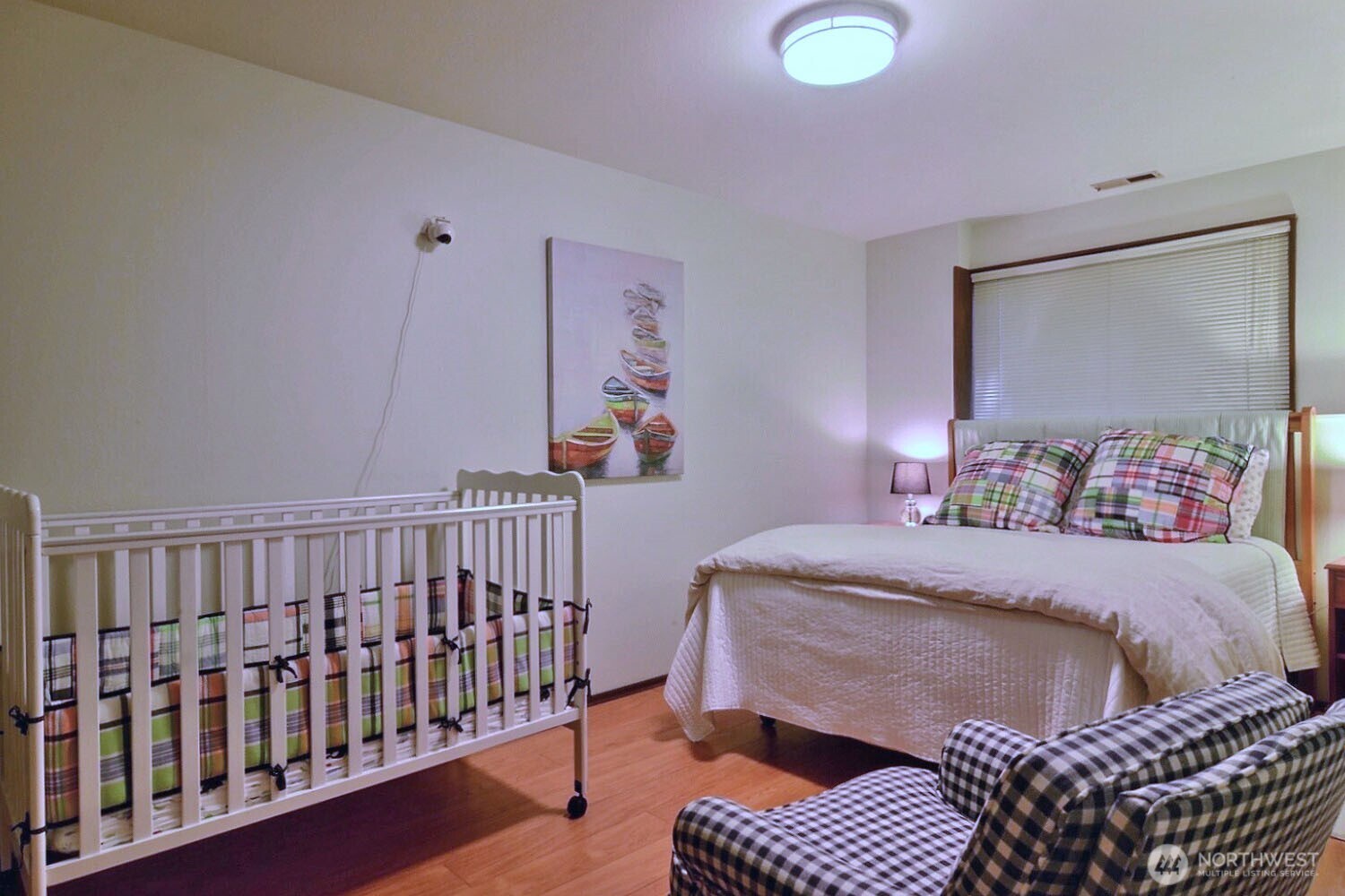 7504 Crescent Beach Rd Nortwest Vaughn, WA 98394 - Photo 26 of 40 a bedroom with a bed and a chandelier