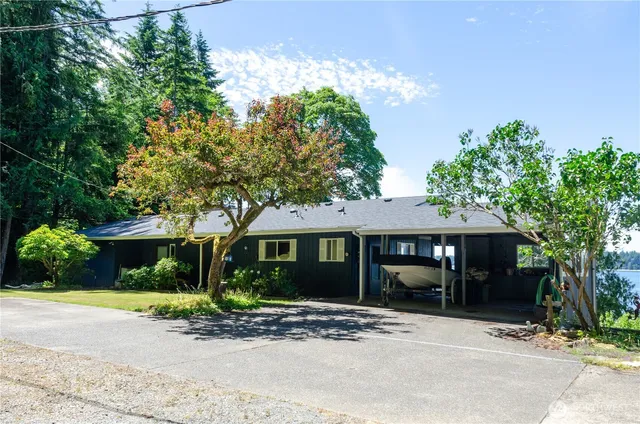 a kitchen with stainless steel appliances granite countertop a sink a stove a counter space and cabinets