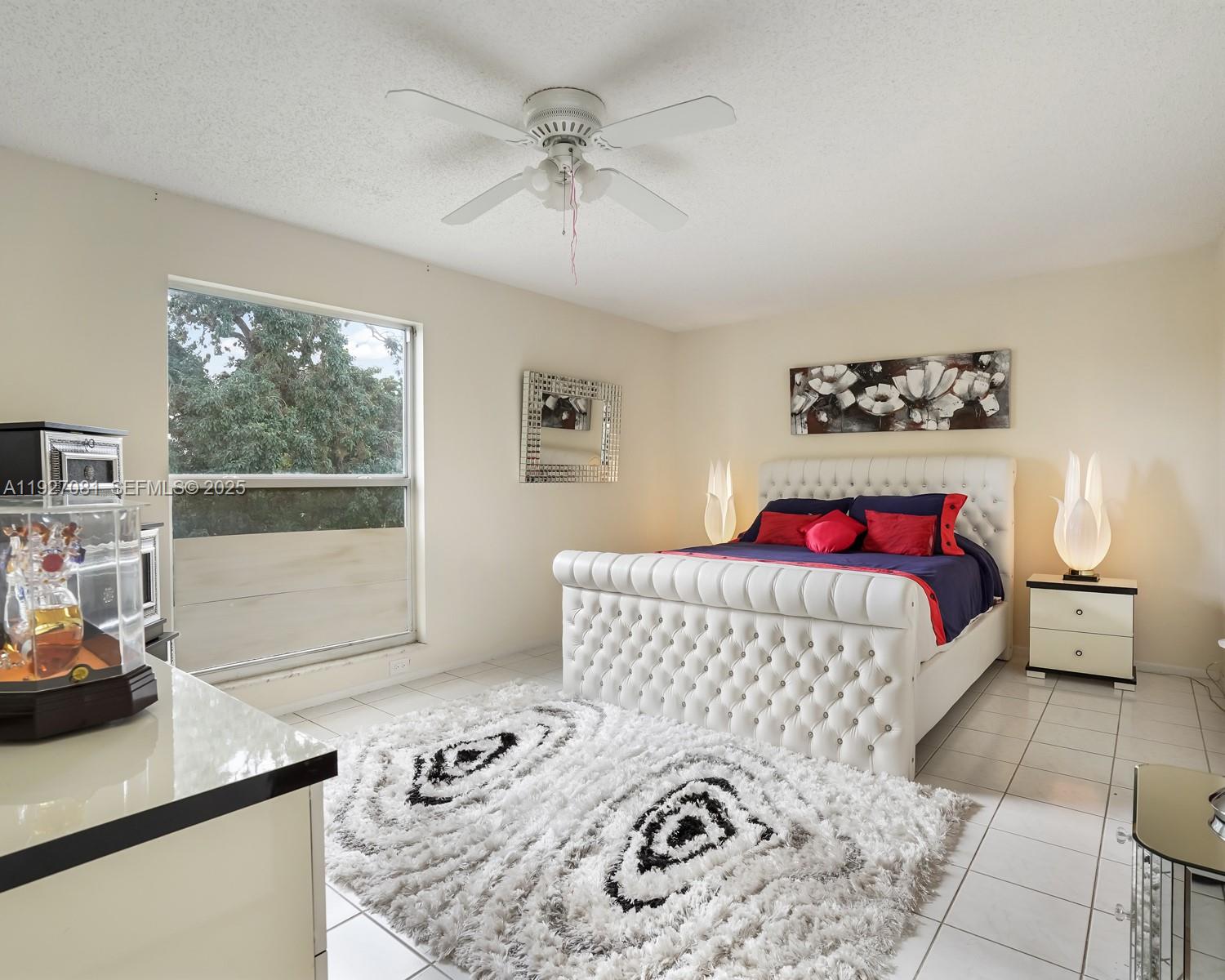 8320 Sands Point Boulevard, Unit M301 Tamarac, FL 33321 - Photo 11 of 36 a bedroom with a bed and a window