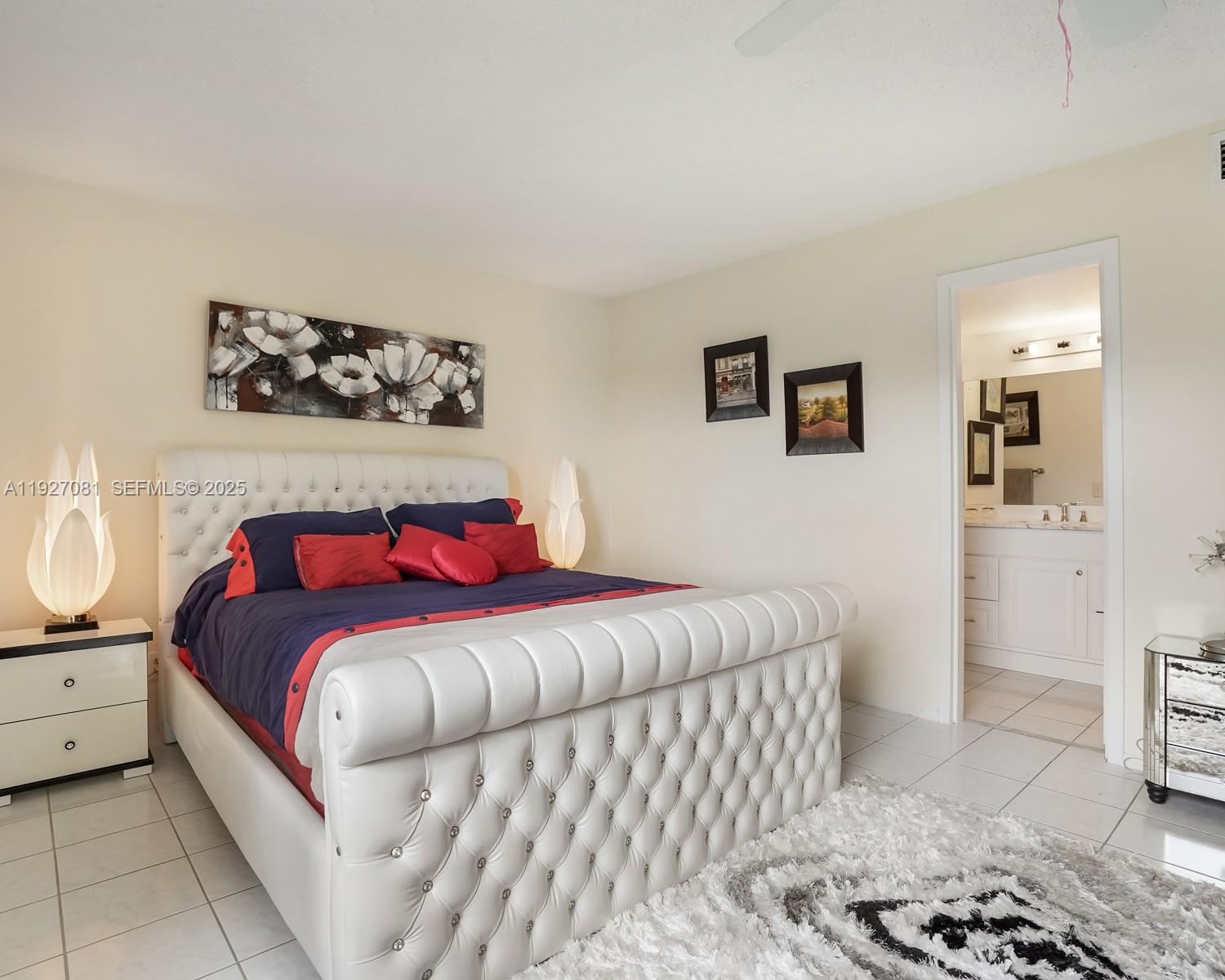 8320 Sands Point Boulevard, Unit M301 Tamarac, FL 33321 - Photo 12 of 36 a bedroom with a bed and a view of bathroom