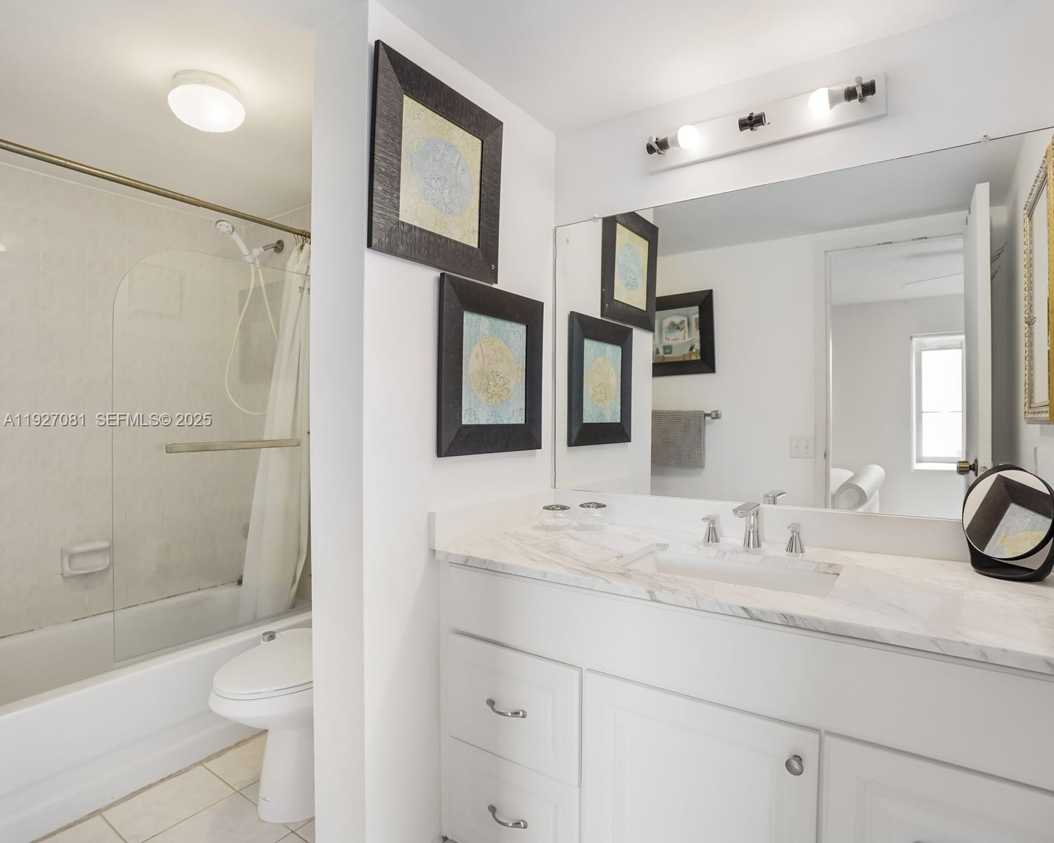 8320 Sands Point Boulevard, Unit M301 Tamarac, FL 33321 - Photo 14 of 36 a bathroom with a sink a toilet and shower