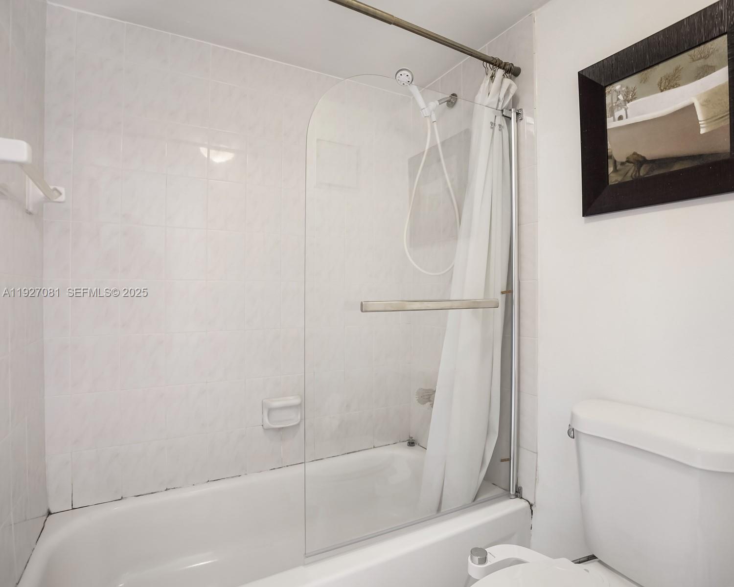 8320 Sands Point Boulevard, Unit M301 Tamarac, FL 33321 - Photo 15 of 36 a bathroom with a shower and a toilet
