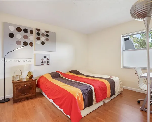 a bathroom with a sink toilet and window
