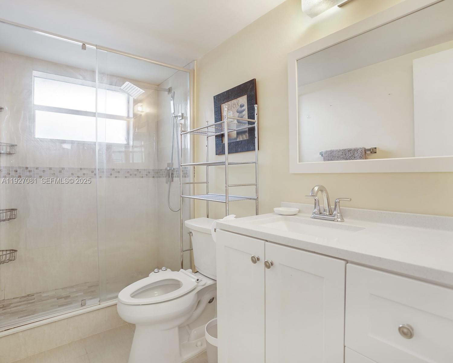 8320 Sands Point Boulevard, Unit M301 Tamarac, FL 33321 - Photo 17 of 36 a bathroom with a sink toilet and window