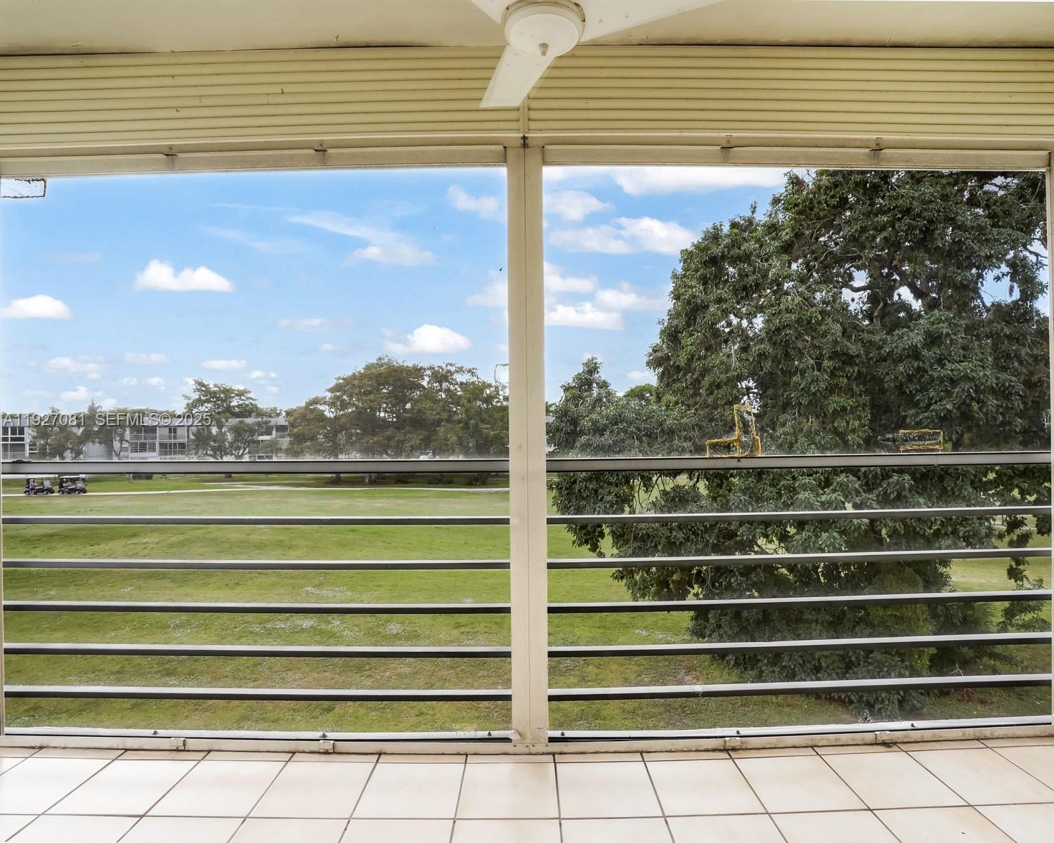 8320 Sands Point Boulevard, Unit M301 Tamarac, FL 33321 - Photo 20 of 36 a view of a balcony with a floor to ceiling window and wooden floor