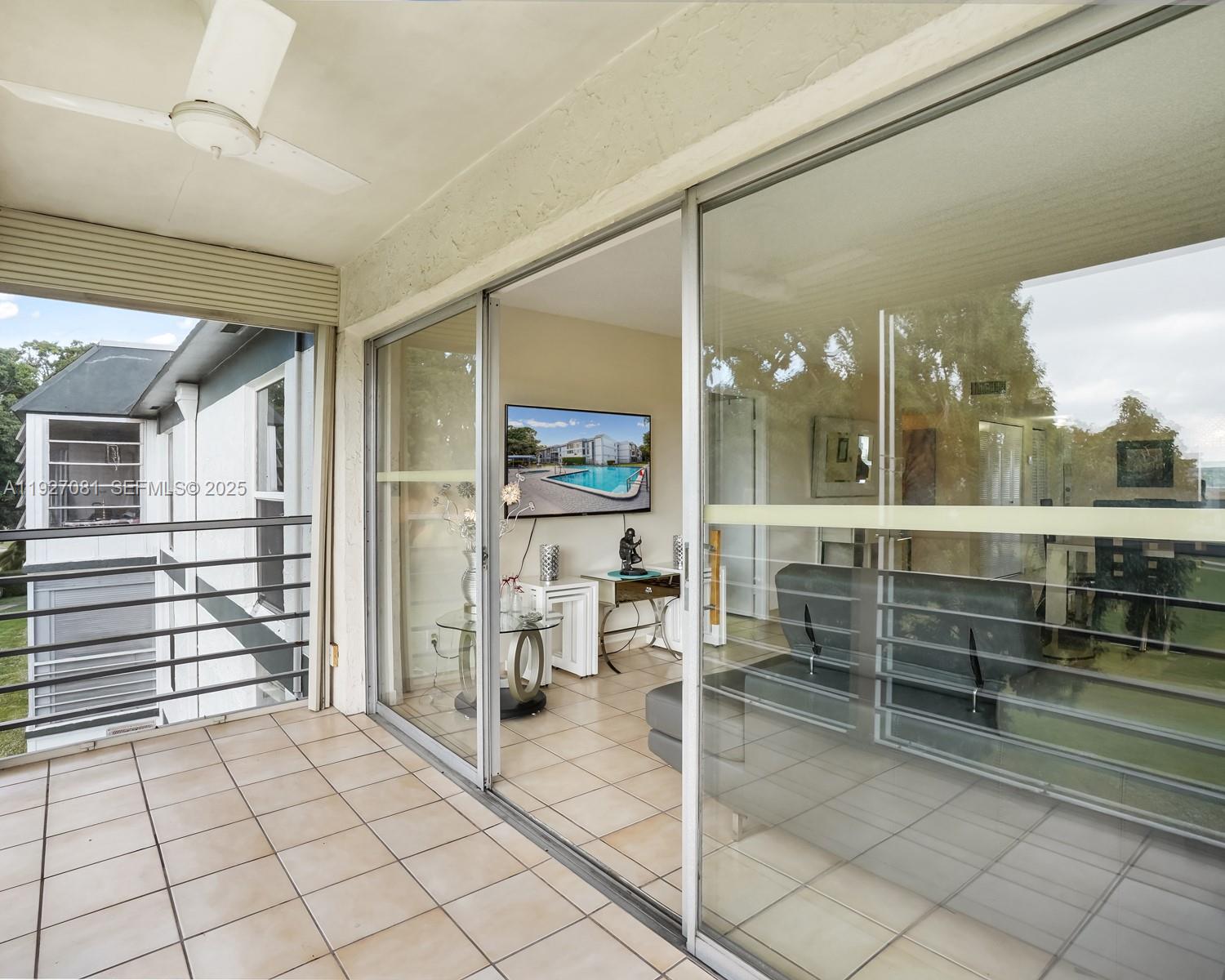 8320 Sands Point Boulevard, Unit M301 Tamarac, FL 33321 - Photo 21 of 36 a room with lots of wooden cabinets and glass door