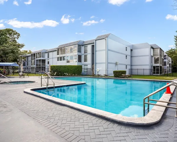 a view of swimming pool with outdoor seating and lake view