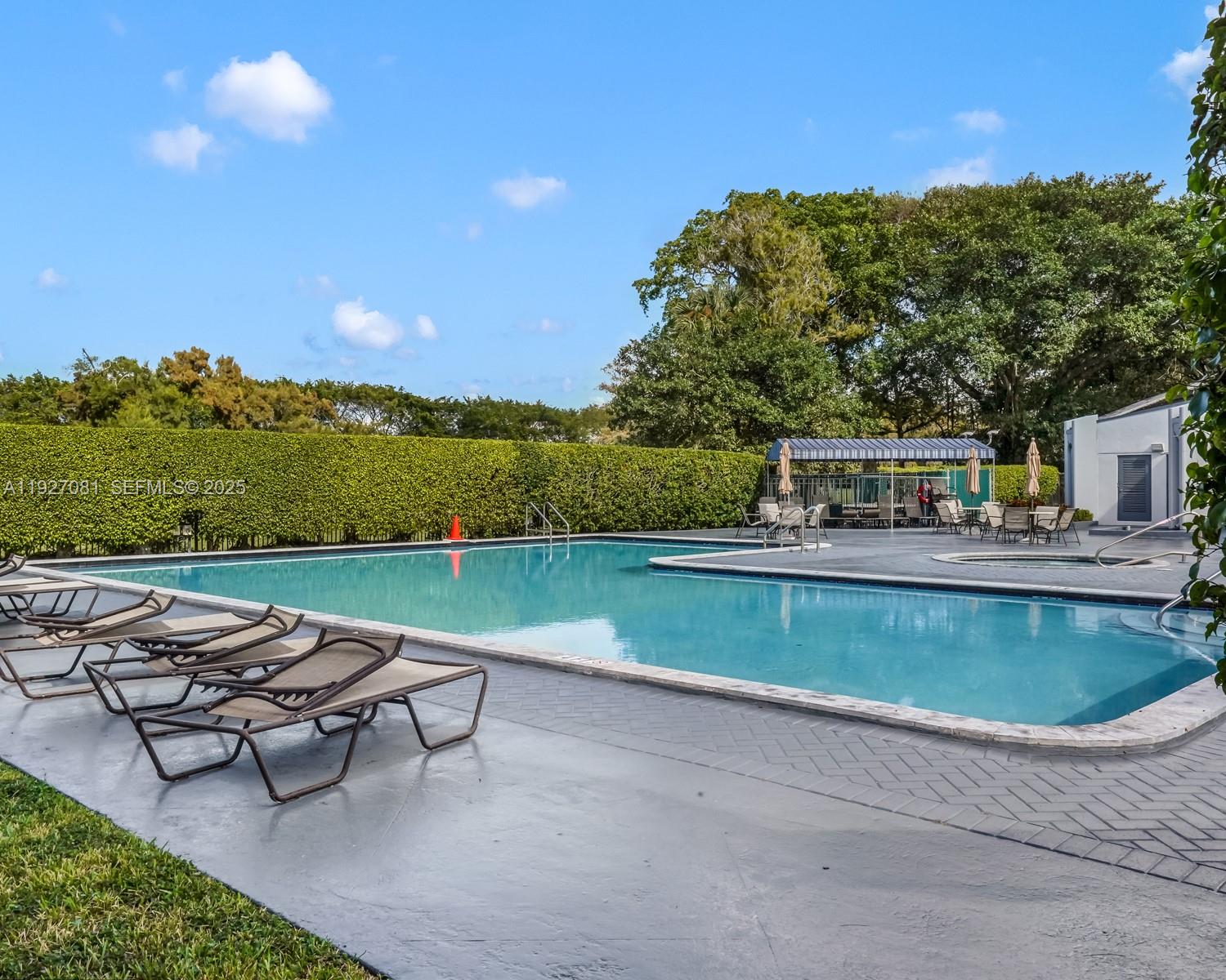 8320 Sands Point Boulevard, Unit M301 Tamarac, FL 33321 - Photo 23 of 36 a view of swimming pool with outdoor seating and lake view