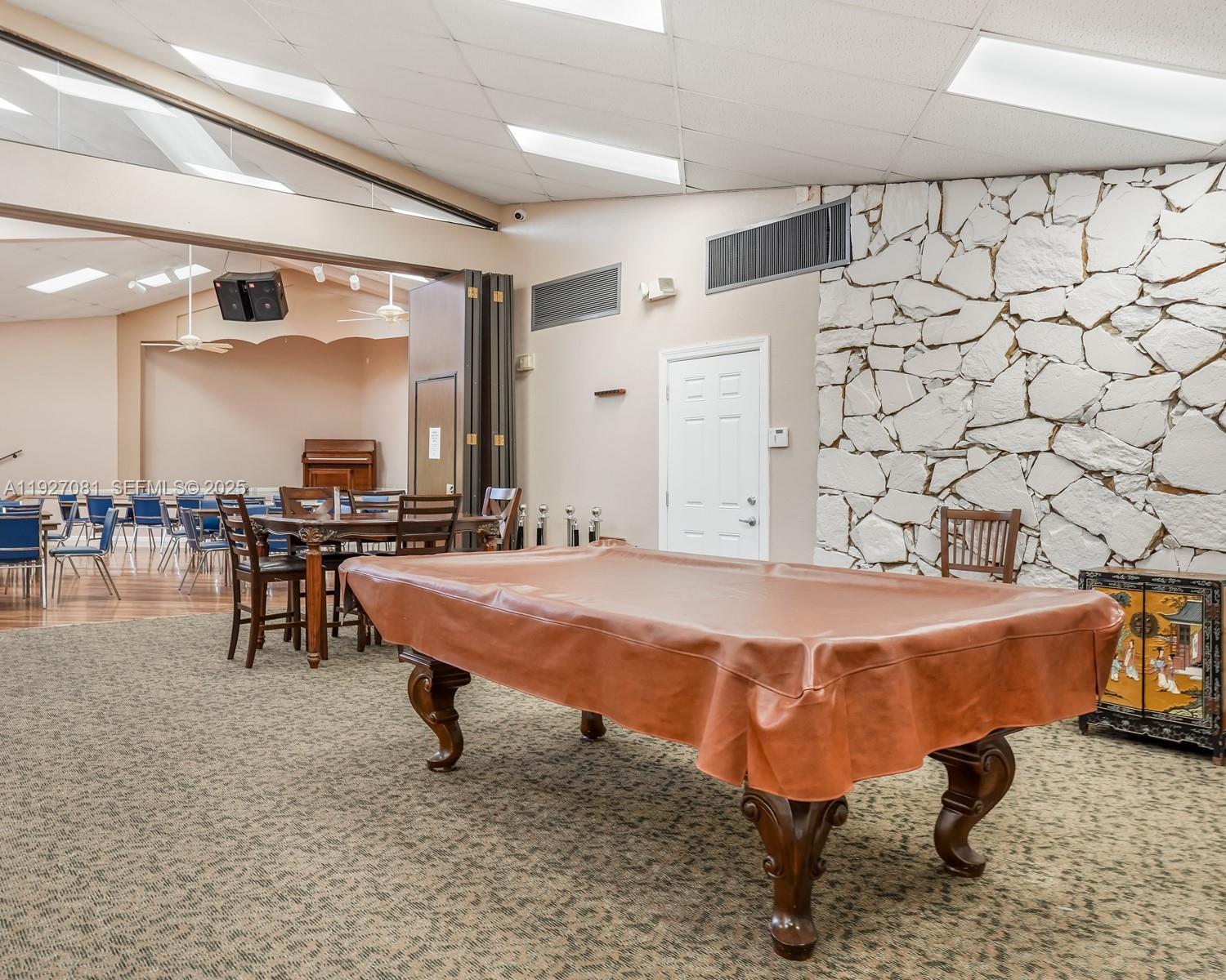 8320 Sands Point Boulevard, Unit M301 Tamarac, FL 33321 - Photo 27 of 36 a outdoor space with pool table and chairs