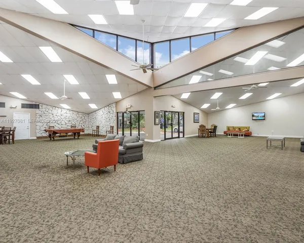 a view of a dining room with lots of furniture wooden floor and chandelier