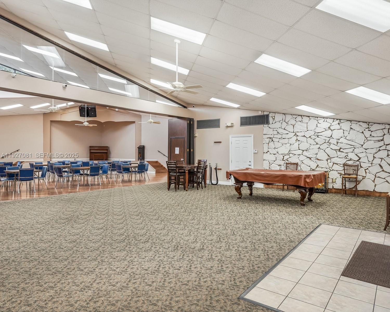 8320 Sands Point Boulevard, Unit M301 Tamarac, FL 33321 - Photo 30 of 36 a living room with furniture and a table