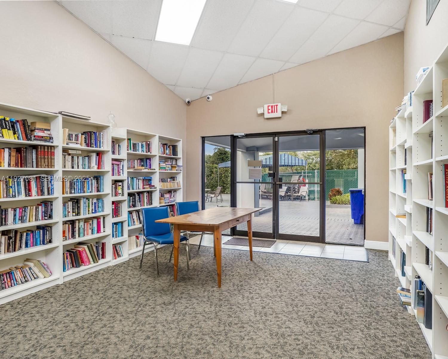 8320 Sands Point Boulevard, Unit M301 Tamarac, FL 33321 - Photo 31 of 36 a reading room with furniture and book shelf