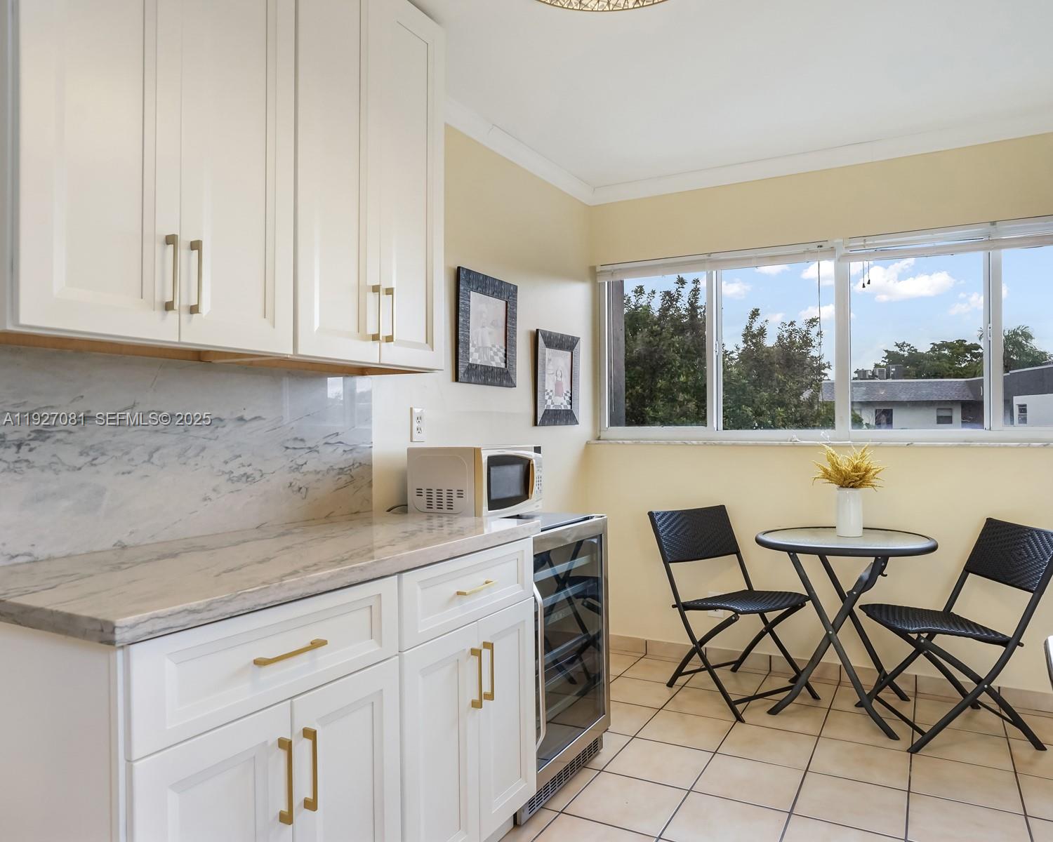 8320 Sands Point Boulevard, Unit M301 Tamarac, FL 33321 - Photo 7 of 36 a kitchen with a sink and cabinets
