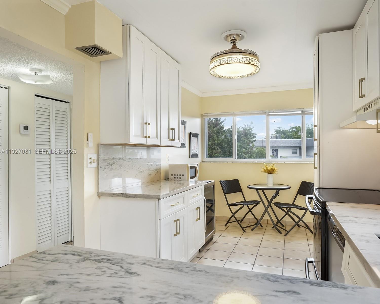 8320 Sands Point Boulevard, Unit M301 Tamarac, FL 33321 - Photo 8 of 36 a kitchen with stainless steel appliances granite countertop a stove and a refrigerator
