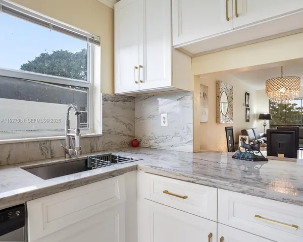a kitchen with white cabinets and appliances
