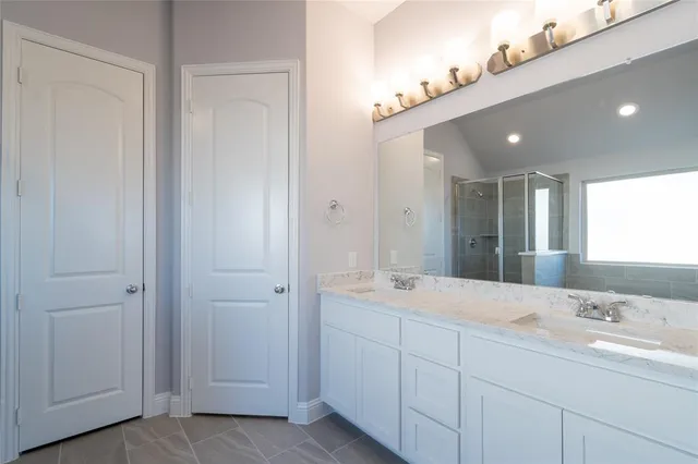 a bathroom with a granite countertop toilet and a sink