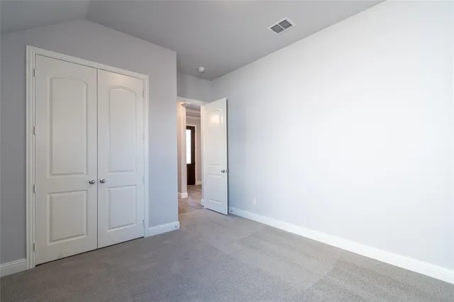a bathroom with a bathtub shower sink vanity mirror and toilet