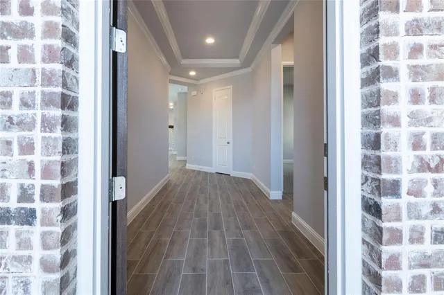 a kitchen with stainless steel appliances granite countertop a sink a stove and a wooden floors