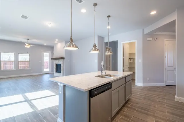 a view of kitchen with livingroom and fireplace