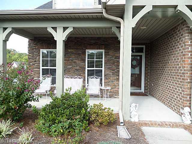 1452 Downington Road Clemmons, NC 27012 - Photo 2 of 16 Exterior Front. Pretty brick and stone exterior with a spacious front porch to enjoy. Front door has a transom and a storm door. Notice the brick step accent.