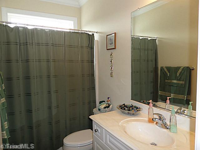 1452 Downington Road Clemmons, NC 27012 - Photo 11 of 16 Bath. Main level hall bathroom has a transom window for natural light, tile floor and a tub/shower combination.
