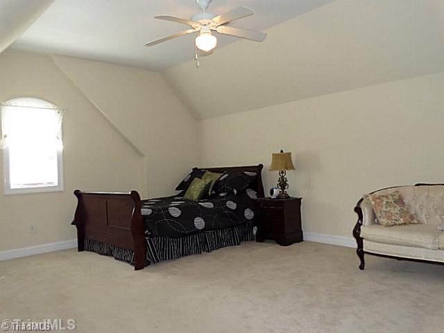 1452 Downington Road Clemmons, NC 27012 - Photo 13 of 16 4th Bedroom. This is a bonus room or upper level fourth bedroom. It features a ceiling fan and eave storage. The closet for this bedroom is steps outside the door by the full bathroom.