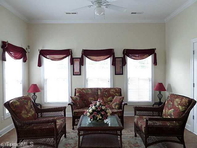 1452 Downington Road Clemmons, NC 27012 - Photo 14 of 16 Sunroom. Sunroom has 9 foot ceilings, ceiling fan, door to the patio. The door on the right is a storage room.