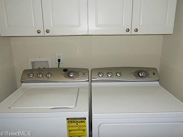 1452 Downington Road Clemmons, NC 27012 - Photo 15 of 16 Laundry Room. Main level laundry area has cabinet storage and the washer and dryer remains.