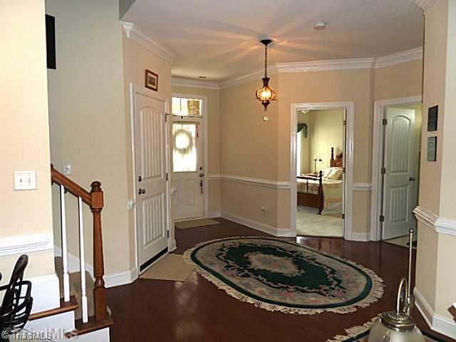 1452 Downington Road Clemmons, NC 27012 - Photo 3 of 16 Entry. Spacious entry has neutral decor, crown molding, chair rail, hardwood floor and an attractive light fixture.