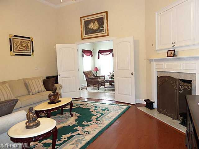 1452 Downington Road Clemmons, NC 27012 - Photo 4 of 16 Den/Family/Great Room. Spacious great room has hardwood floors, 12 foot ceilings, crown molding, FP with gas logs and double doors to the Sunroom.