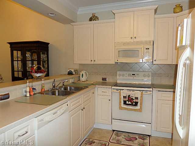 1452 Downington Road Clemmons, NC 27012 - Photo 6 of 16 Kitchen. Light and bright neutral kitchen. Pantry and all the appliances remain.