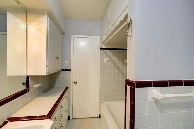 a bathroom with a bathtub and a shower