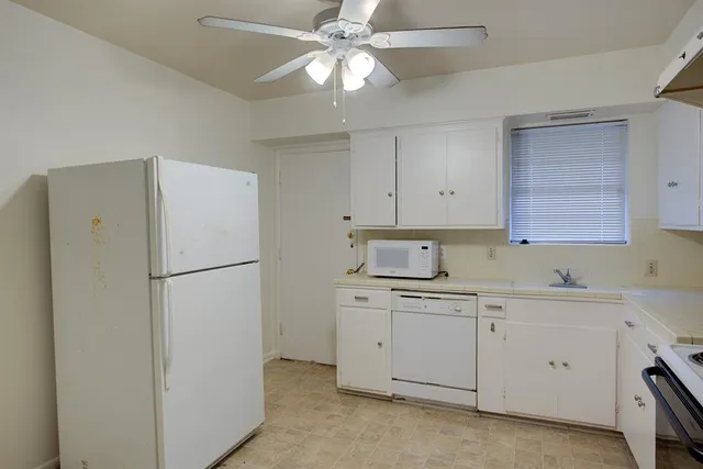 a white refrigerator freezer sitting inside of a kitchen