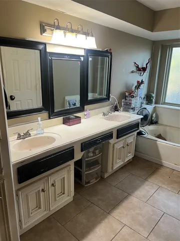 a bathroom with a double vanity sink and a mirror