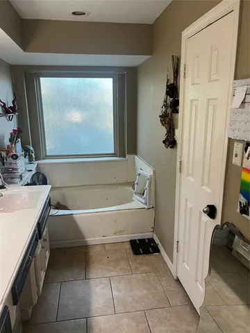 a bathroom with a bathtub and a sink