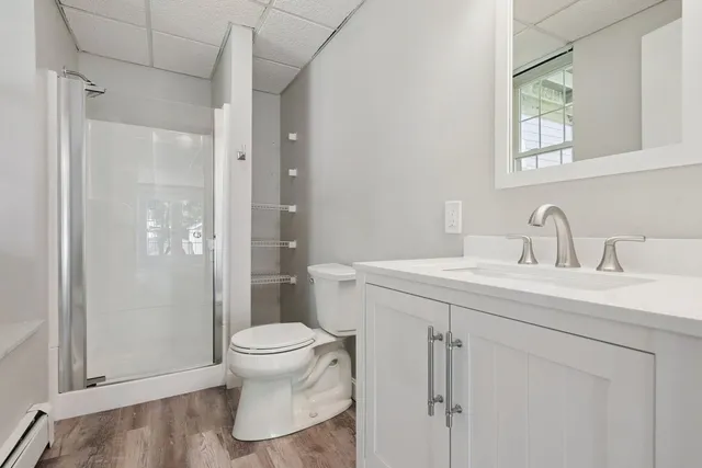 a bathroom with a sink a toilet and shower