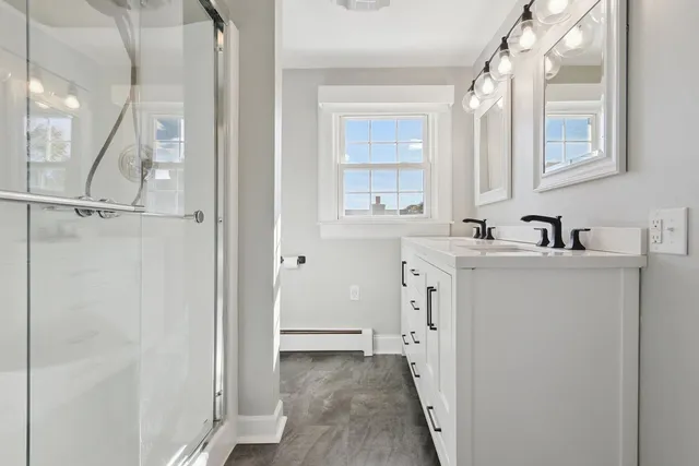 an empty room with wooden floor and fireplace