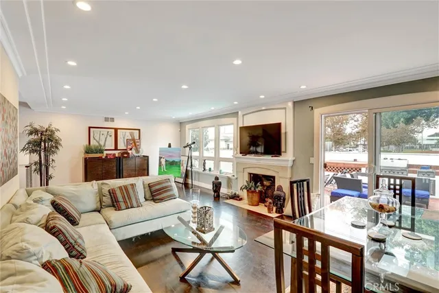 a living room with furniture flat screen tv and a large window