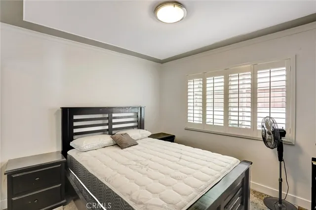 a bed sitting in a bedroom next to a window