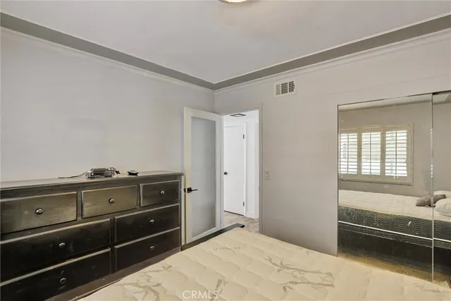 a room with a dresser and a window