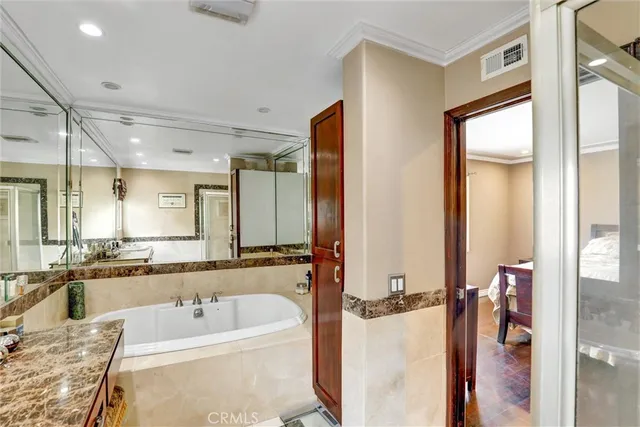 a bathroom with a tub sink and mirror