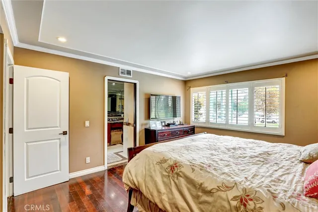 a spacious bedroom with a bed and a large window